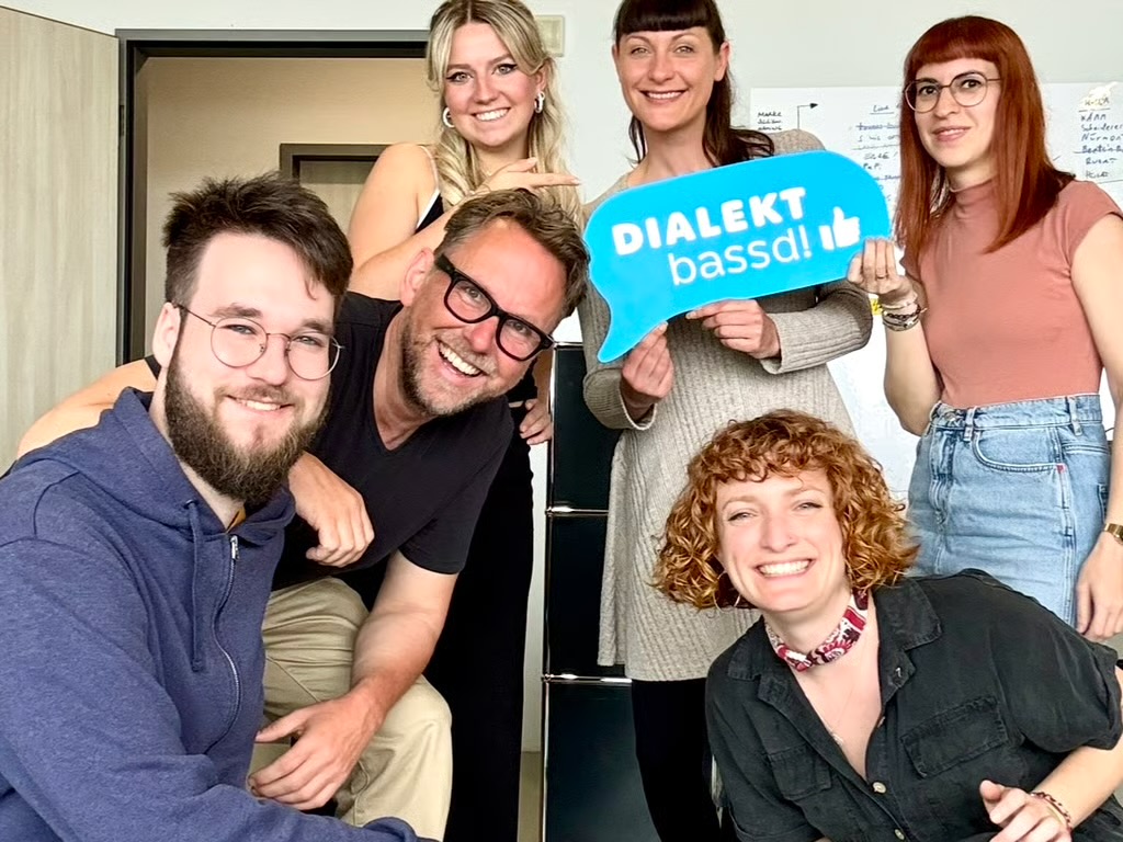 MACHEN! Team mit Dialekt-bassd-Schild
